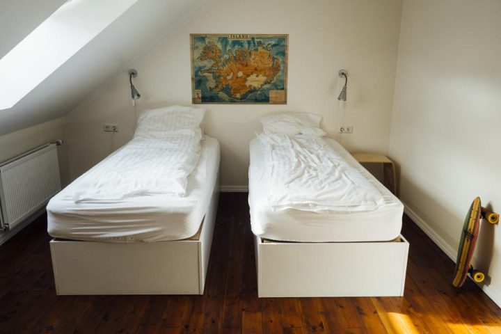 Morning light falling across two beds in a quiet bedroom
